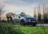 blue bmw m 3 coupe on green grass field during daytime