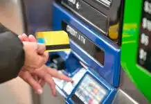 a person using a credit card to pay for a machine