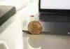 silver round coin on white table