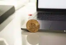 silver round coin on white table