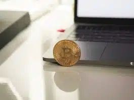 silver round coin on white table